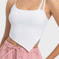 Stylish white asymmetrical neck active cami paired with pink lounge shorts, perfect for workouts and casual outings.