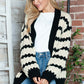 Woman wearing Bella Road Striped Contrast Open Front Long Sleeve Cardigan, cozy and stylish with unique striped design.