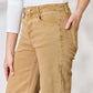 Woman modeling Risen Fringe Hem Wide Leg Jeans in beige with pocket details. High-waisted, flattering fit.