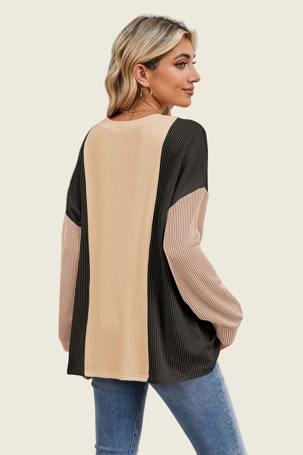 Woman wearing a Double Take Texture Contrast Long Sleeve T-Shirt in stylish color combo, showing back design and texture contrast.