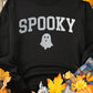 "Bella Road SPOOKY sweatshirt on autumn leaves, showcasing cute ghost design, perfect for cozy spooky occasions"