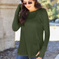 Woman wearing round neck long sleeve t-shirt in forest green paired with jeans, standing outdoors with sunglasses.