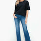 Model wearing bytos Cat's Whiskers High Rise Straight Jeans with a black top, showcasing a stylish and modern outfit.