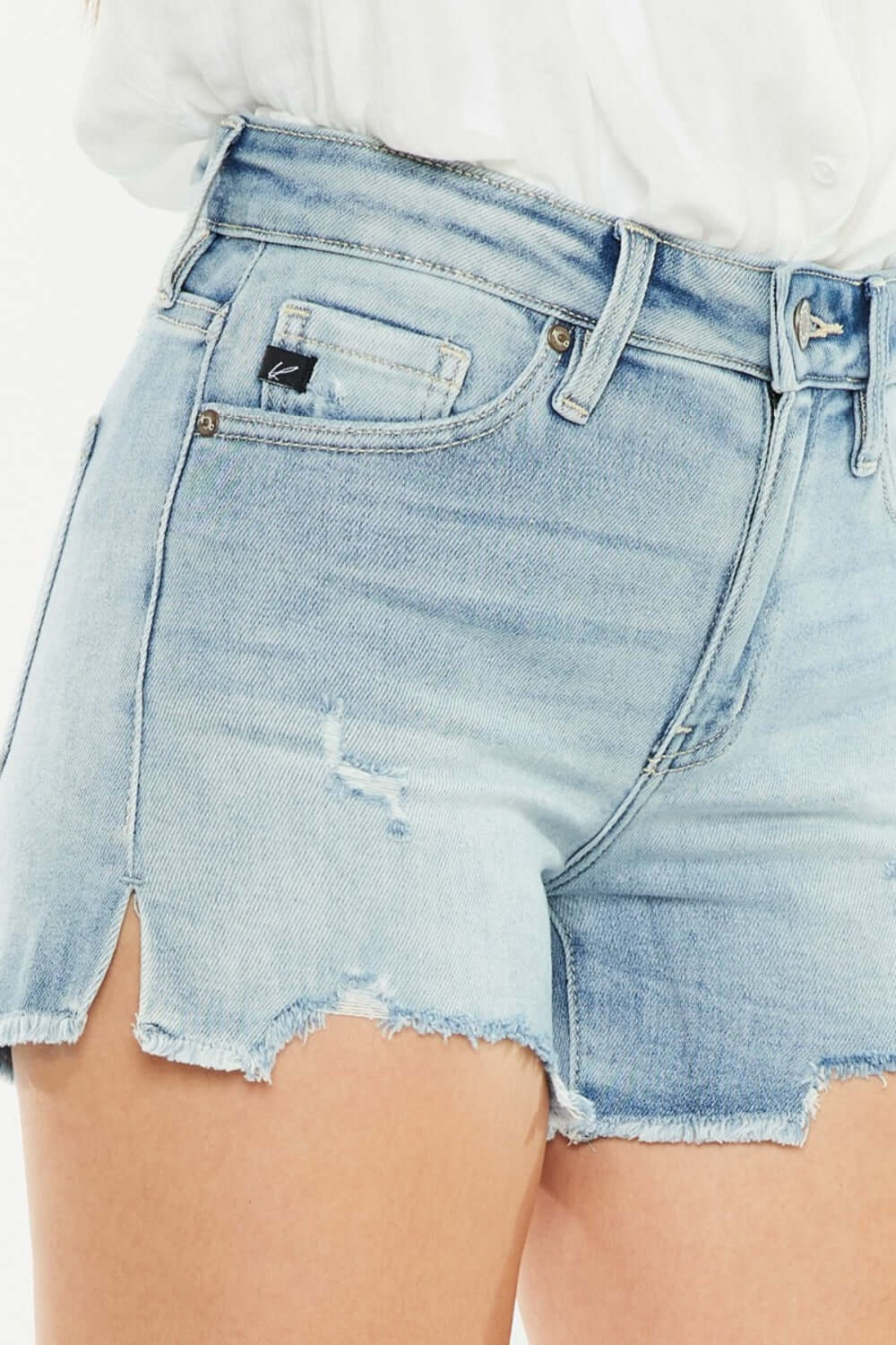 High rise side slit denim shorts with trendy side details and flattering high-waist, perfect for summer wardrobe.