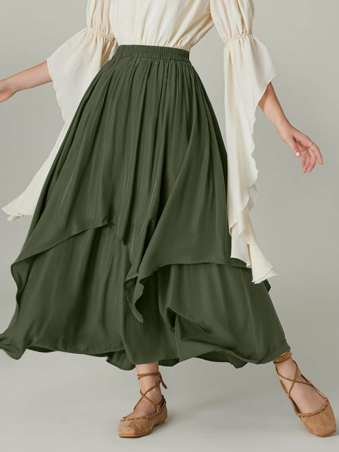 Army green Bella Road skirt with smocked waist and ruched layers, paired with flowy white blouse and strappy sandals.