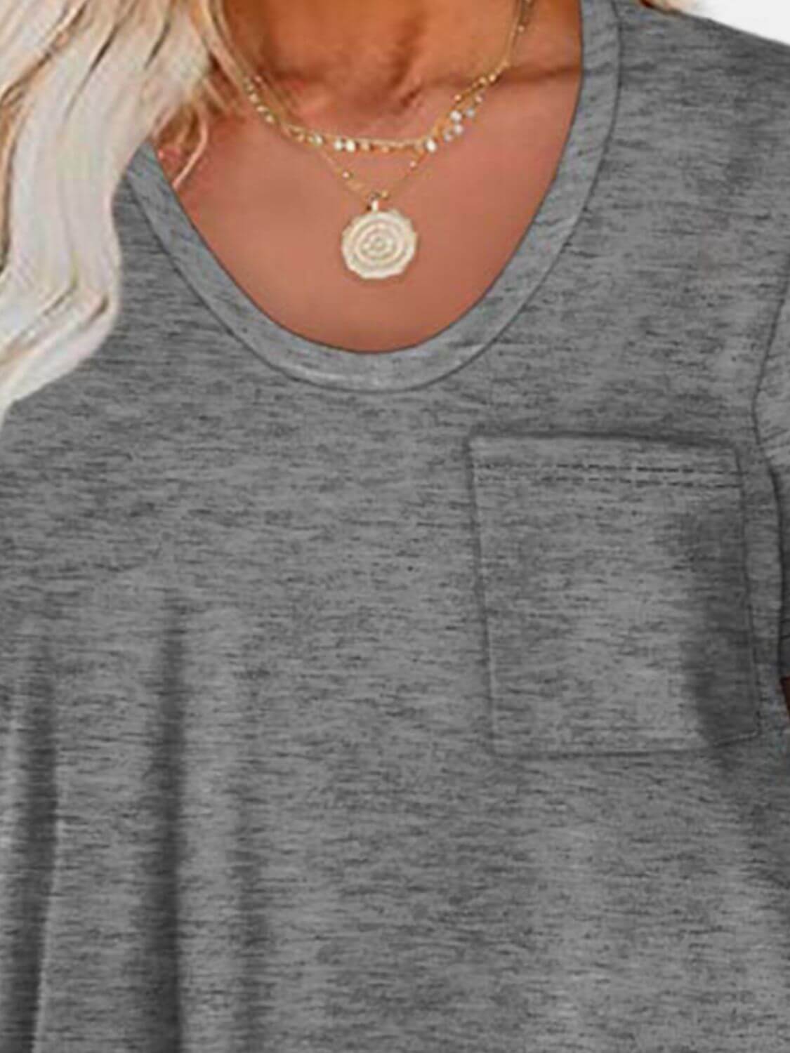 Woman wearing Bella Road Round Neck Long Sleeve T-Shirt with a pocket, necklace visible, and slightly stretchy gray fabric.