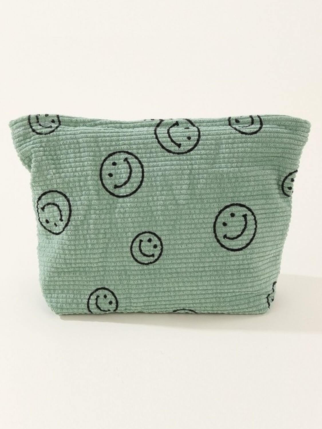 Stylish Zenana corduroy clutch bag featuring a charming green color and playful smiley face print, perfect for fashion-savvy individuals.