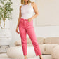 Woman wearing RFM Jeans' Crop Dylan Full Size Tummy Control High Waist Raw Hem Jeans in pink, showing high-waist design and comfortable fit.