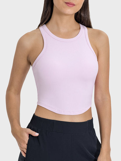 Millennia round neck racerback active tank in soft pink, featuring a sleek design and moderate stretch for comfort.