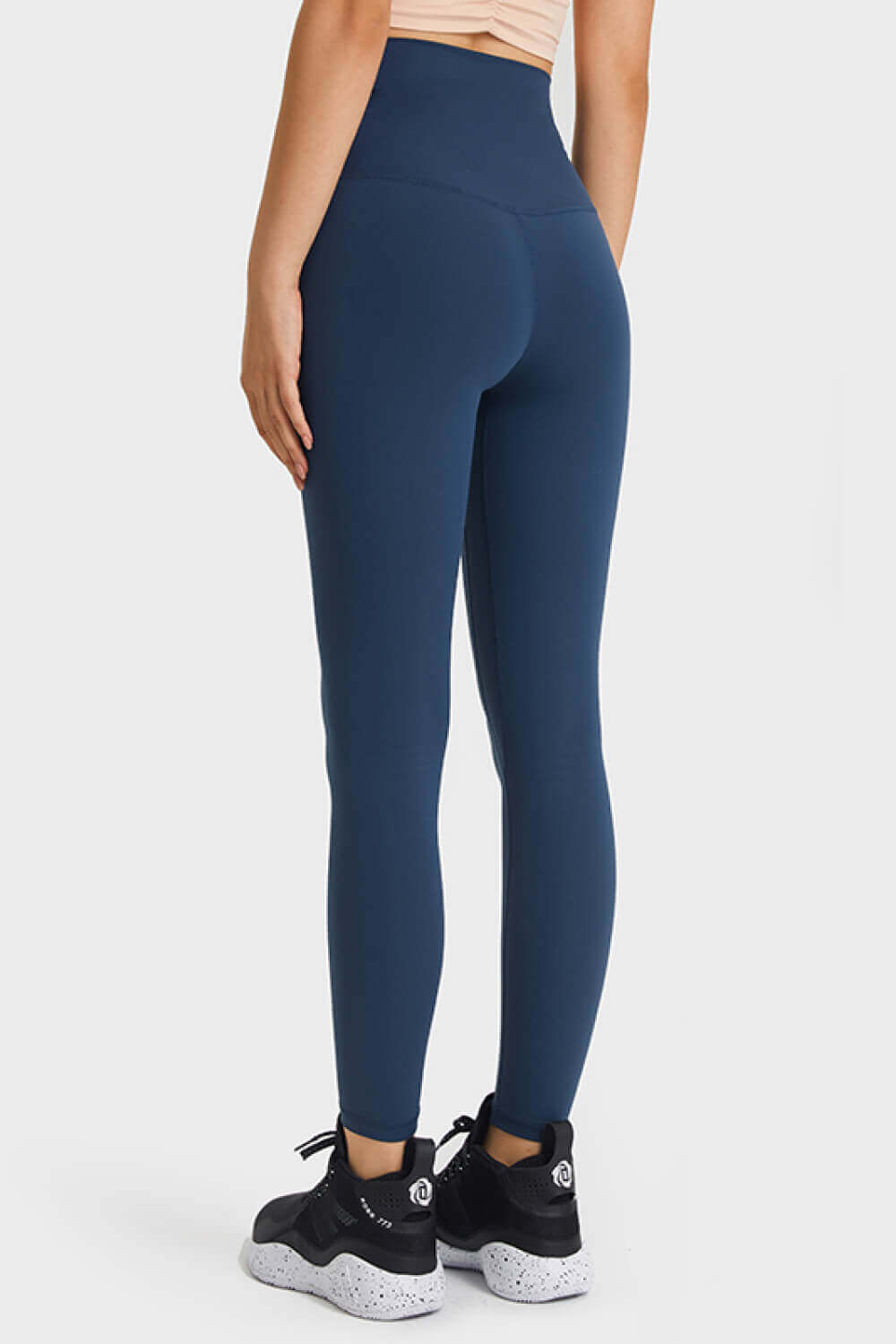 Model wearing Millennia Ultra Soft High Waist Leggings in navy, showcasing a flattering fit with an elastic waistband.