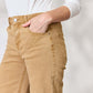 Woman wearing Risen jeans with wide-leg design and pocketed detail in a trendy beige color.