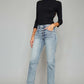 Model wearing High Waist Button Fly Raw Hem Cropped Straight Jeans with a black top and beige heels