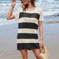 Stylish woman in black and white striped openwork cover-up at the beach, perfect for summer fashion.