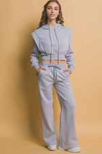 Model wearing Love Tree drawstring wide leg sweatpants with pockets, styled with a matching cropped hoodie in gray.