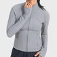 Woman wearing a gray Millennia Zip-Up Long Sleeve Sports Jacket, perfect for workouts and activewear style.