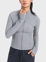 Woman wearing a gray Millennia Zip-Up Long Sleeve Sports Jacket, perfect for workouts and activewear style.