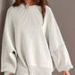 Woman wearing Double Take Side Slit Round Neck Long Sleeve Sweater in white cotton blend.