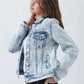 Woman wearing button-up washed denim jacket from Risen Jeans, striking a casual pose against a white background.