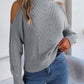 Woman wearing Bella Road Cable-Knit Turtleneck Cold Shoulder Sweater in gray, showcasing trendy cut-out shoulders and cozy knit design.