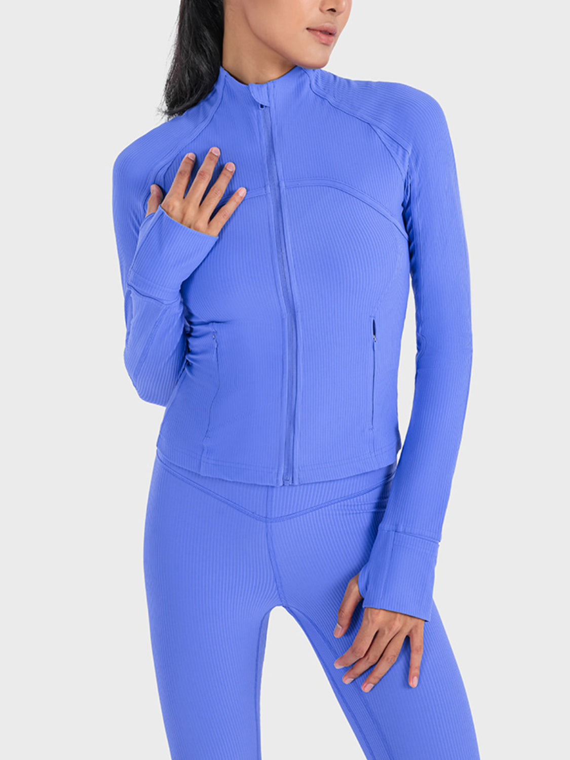 Woman wearing a Cobalt Blue Millennia Zip-Up Long Sleeve Sports Jacket, perfect for workouts and stylish activities.