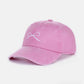 Pink bow embroidered washed cotton cap, stylish and feminine accessory made from comfortable and breathable cotton material.