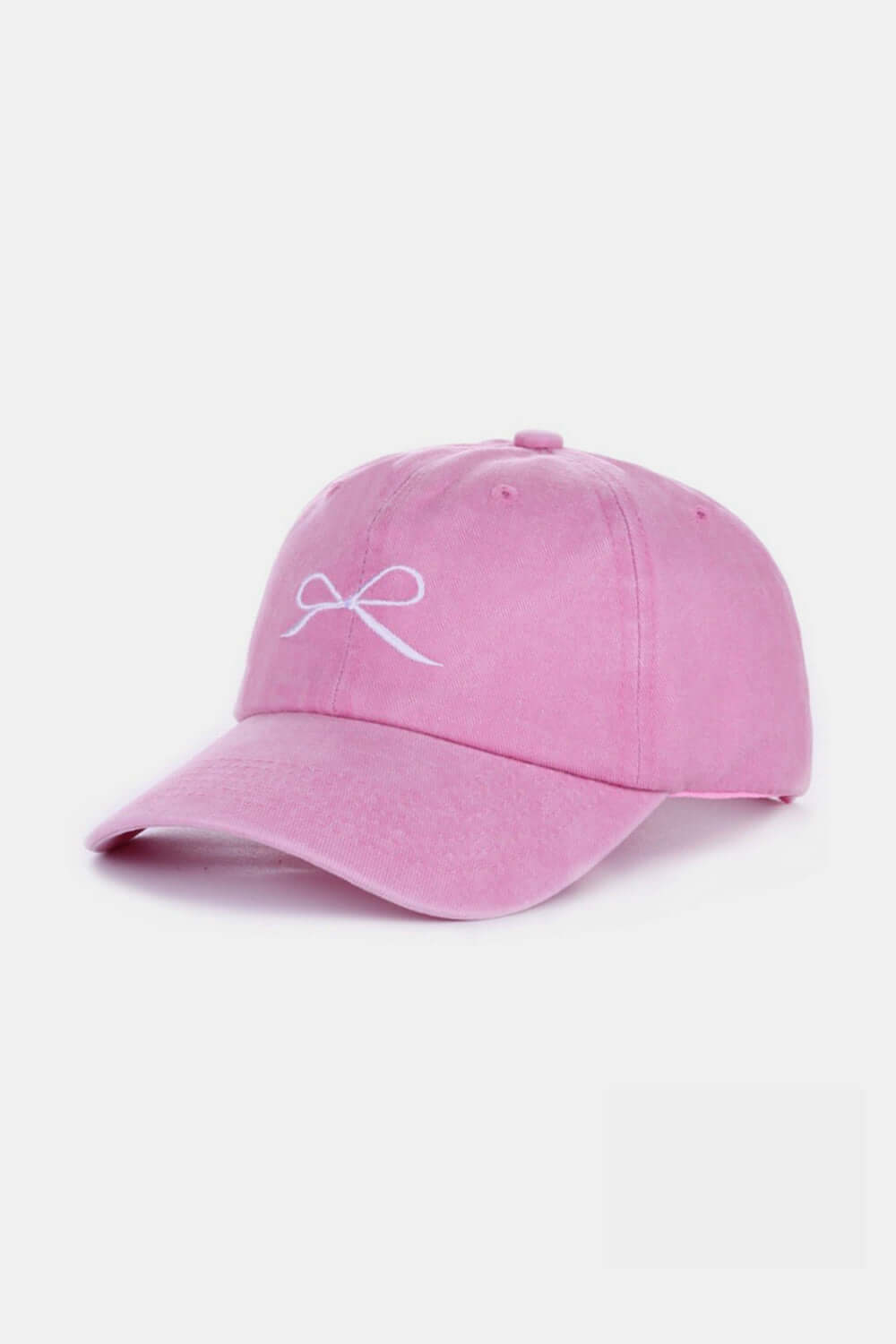 Pink bow embroidered washed cotton cap, stylish and feminine accessory made from comfortable and breathable cotton material.