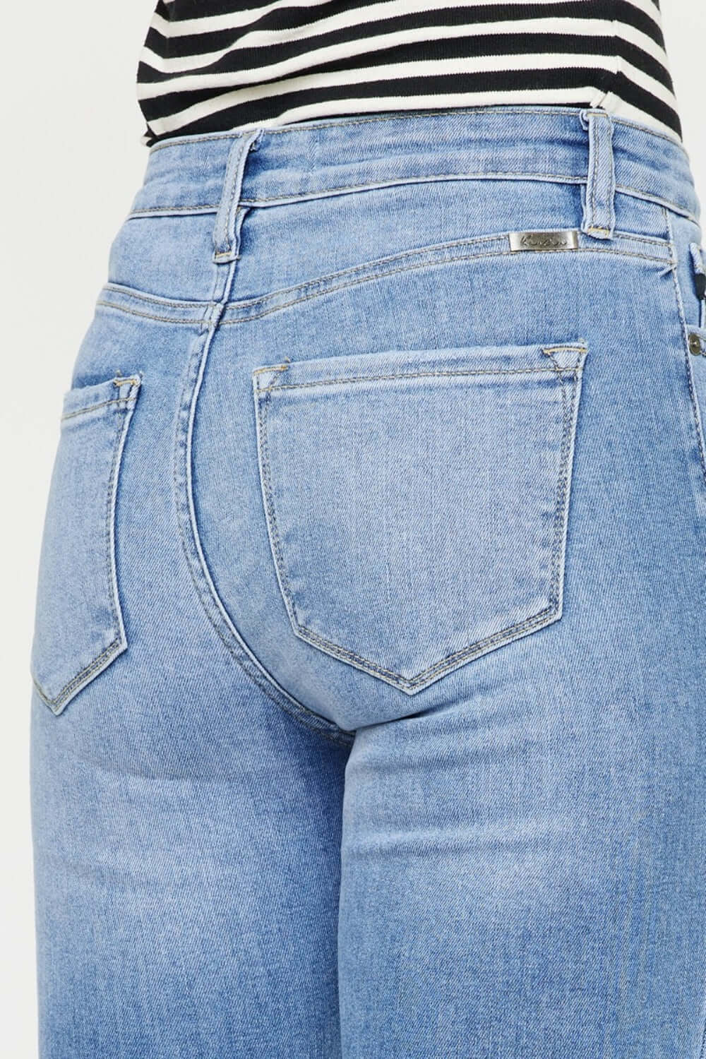 Close-up of Distressed Cat's Whiskers Button Fly Jeans, showcasing the back pocket and light blue denim with a trendy worn-in look.