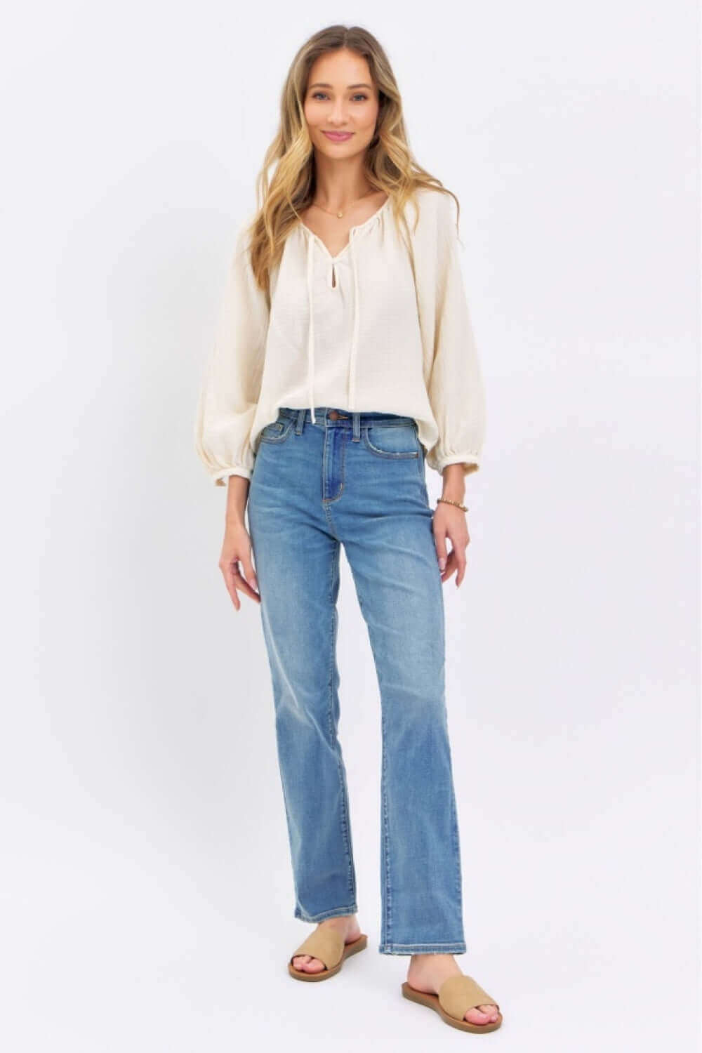 Woman wearing High Waist Straight Judy Blue Jeans styled with a cream blouse and sandals