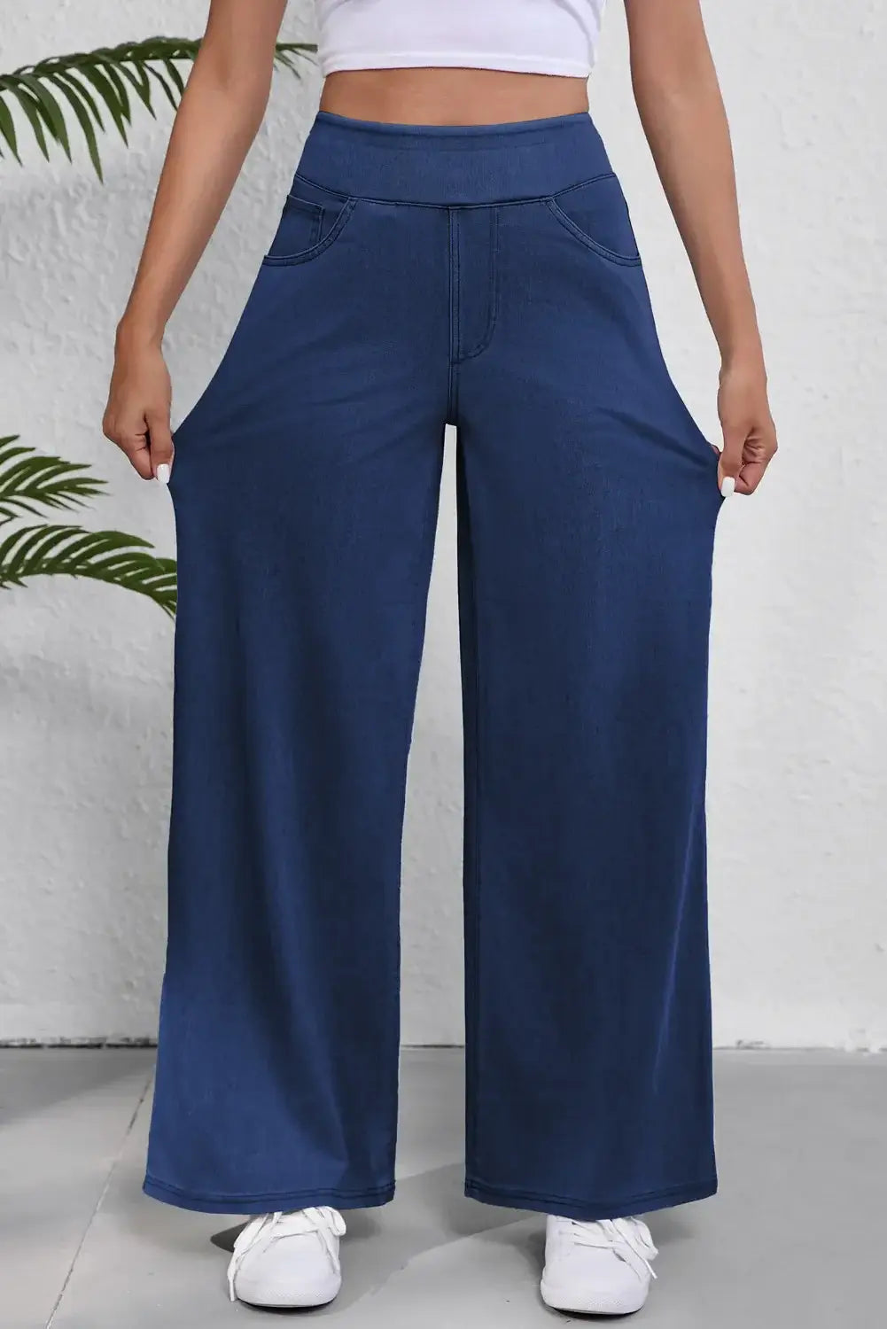 Women's wide leg jeans with pockets in blue, showcasing a relaxed fit and stretch fabric for comfort and style.