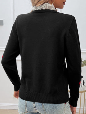 Woman wearing Devine Lace Detail Heart Long Sleeve Sweater in black, showing back view with lace collar, long sleeves, and heart details.