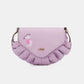 Nicole Lee USA Graphic Crossbody Bag in light purple with ruffled edges and graphic design on flap.