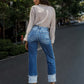 Woman wearing Stepped Waist Raw Hem Rolled Straight Jeans on city street