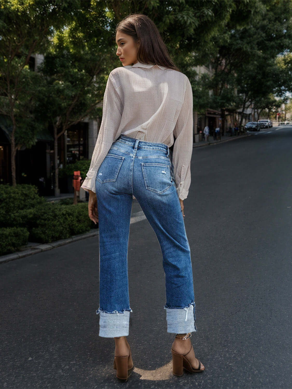 Woman wearing Stepped Waist Raw Hem Rolled Straight Jeans on city street