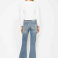 Back view of a woman wearing Judy Blue tummy control embroidered pocket bootcut jeans with a white top.