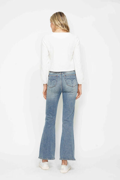 Back view of a woman wearing Judy Blue tummy control embroidered pocket bootcut jeans with a white top.