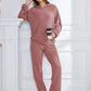 Woman in dusty pink Bella Road hoodie and pants set, relaxed fit, holding coffee, perfect for comfort and style.