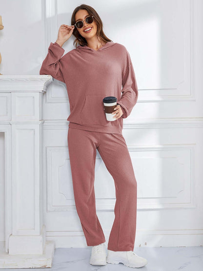 Woman in dusty pink Bella Road hoodie and pants set, relaxed fit, holding coffee, perfect for comfort and style.