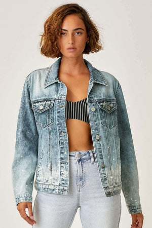 Stylish woman wearing button-up ombre washed denim jacket by Risen Jeans, showing off trendy gradient color effect with casual look.