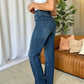 High Rise Straight Tummy Control Jeans with flattering high-waist design and straight-leg cut in living room setting