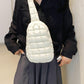 Trendy white quilted nylon crossbody bag in medium size worn by woman in stylish outfit.