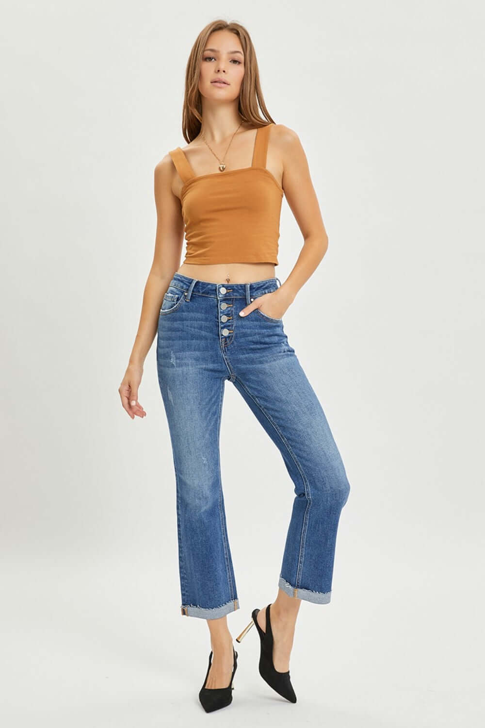 Risen Jeans Button-Fly Cropped Bootcut Jeans with stylish retro button closure, modeled with tan cropped top and black heels.