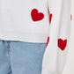 Bella Road Heart Round Neck Dropped Shoulder Sweater with red heart detailing and slightly stretchy fabric.