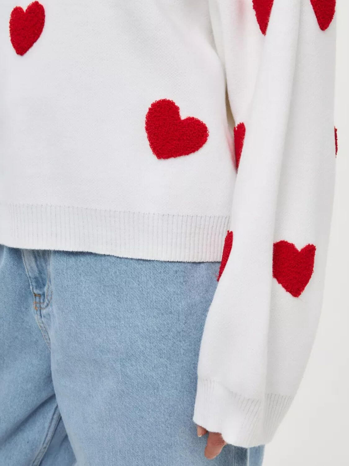 Bella Road Heart Round Neck Dropped Shoulder Sweater with red heart detailing and slightly stretchy fabric.