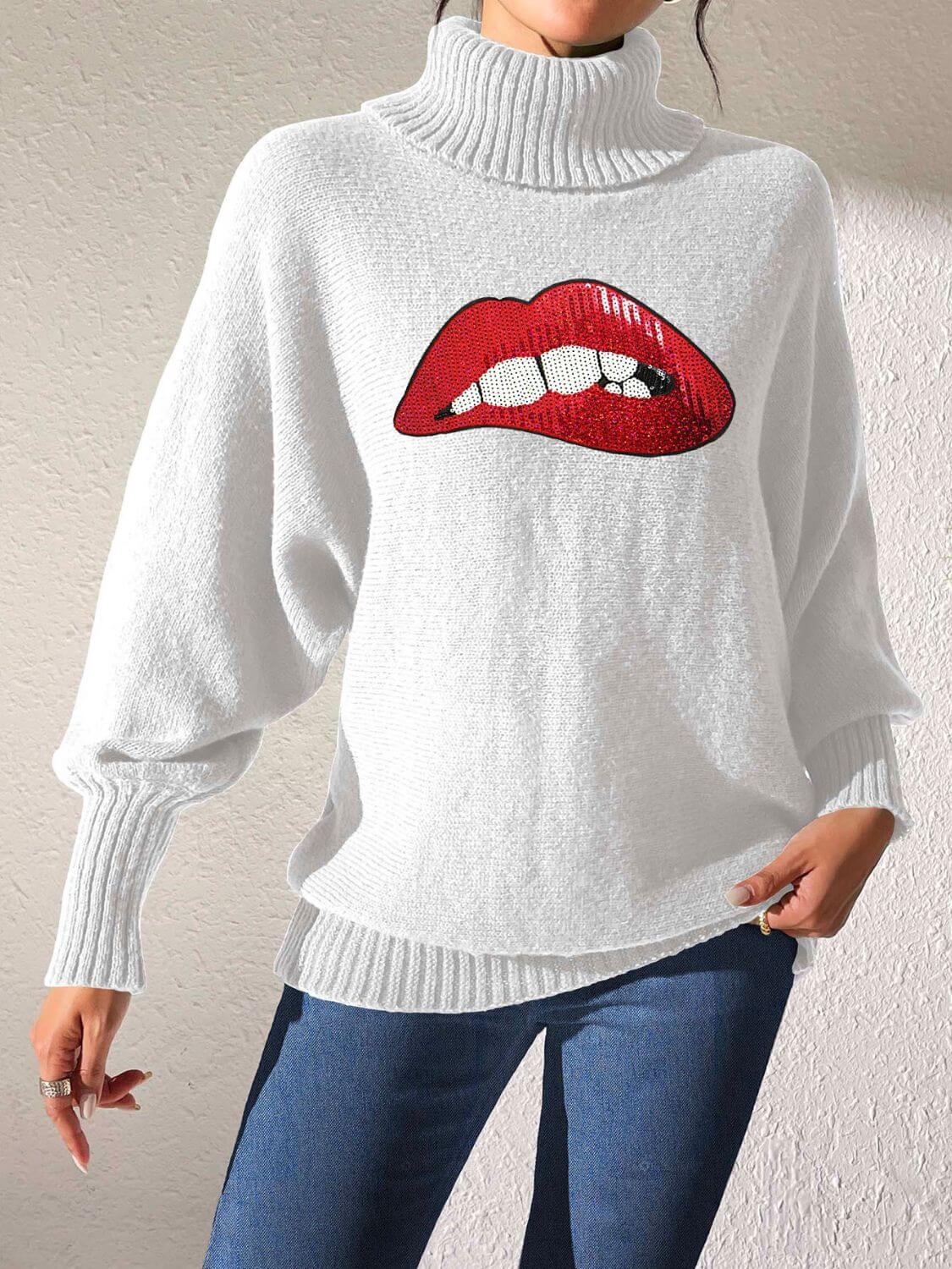 Woman wearing Bella Road Lip Turtleneck Long Sleeve Sweater in white, featuring a bold red lip graphic, paired with blue jeans.