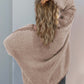 Woman wearing a cozy Double Take Contrast Open Front Dropped Shoulder Cardigan in neutral tones, showing off chic back design.