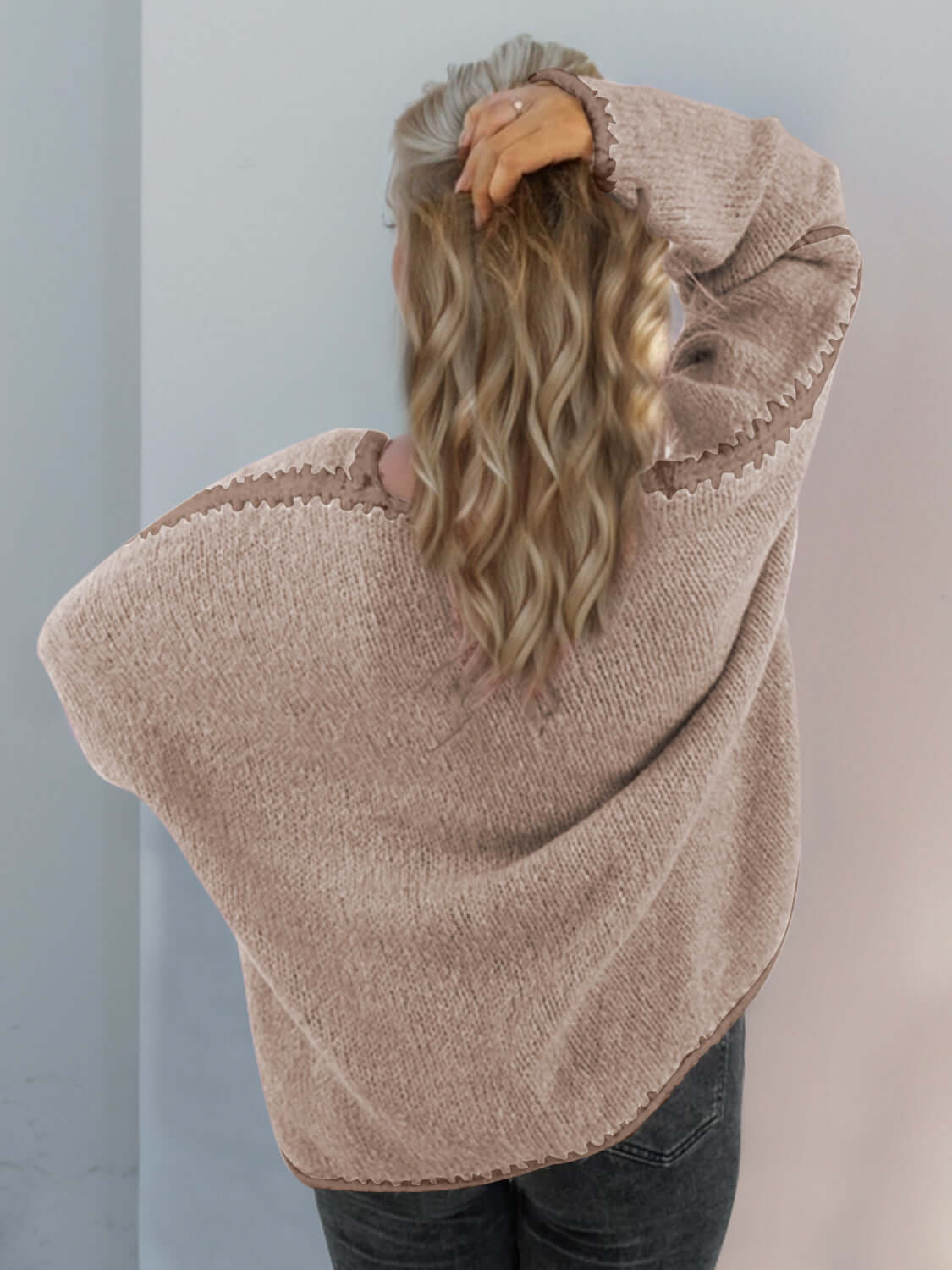 Woman wearing a cozy Double Take Contrast Open Front Dropped Shoulder Cardigan in neutral tones, showing off chic back design.