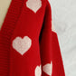 Close-up of Bella Road Heart Open Front Long Sleeve Cardigan in red with white heart patterns.