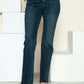 Judy Blue button fly hem destroy jeans showcasing trendy distressed details against a stylish backdrop.