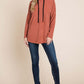 Woman wearing BOMBOM Contrast Drawstring Drop Shoulder Knit Hoodie with long sleeves and jeans, showcasing a cozy and stylish look.