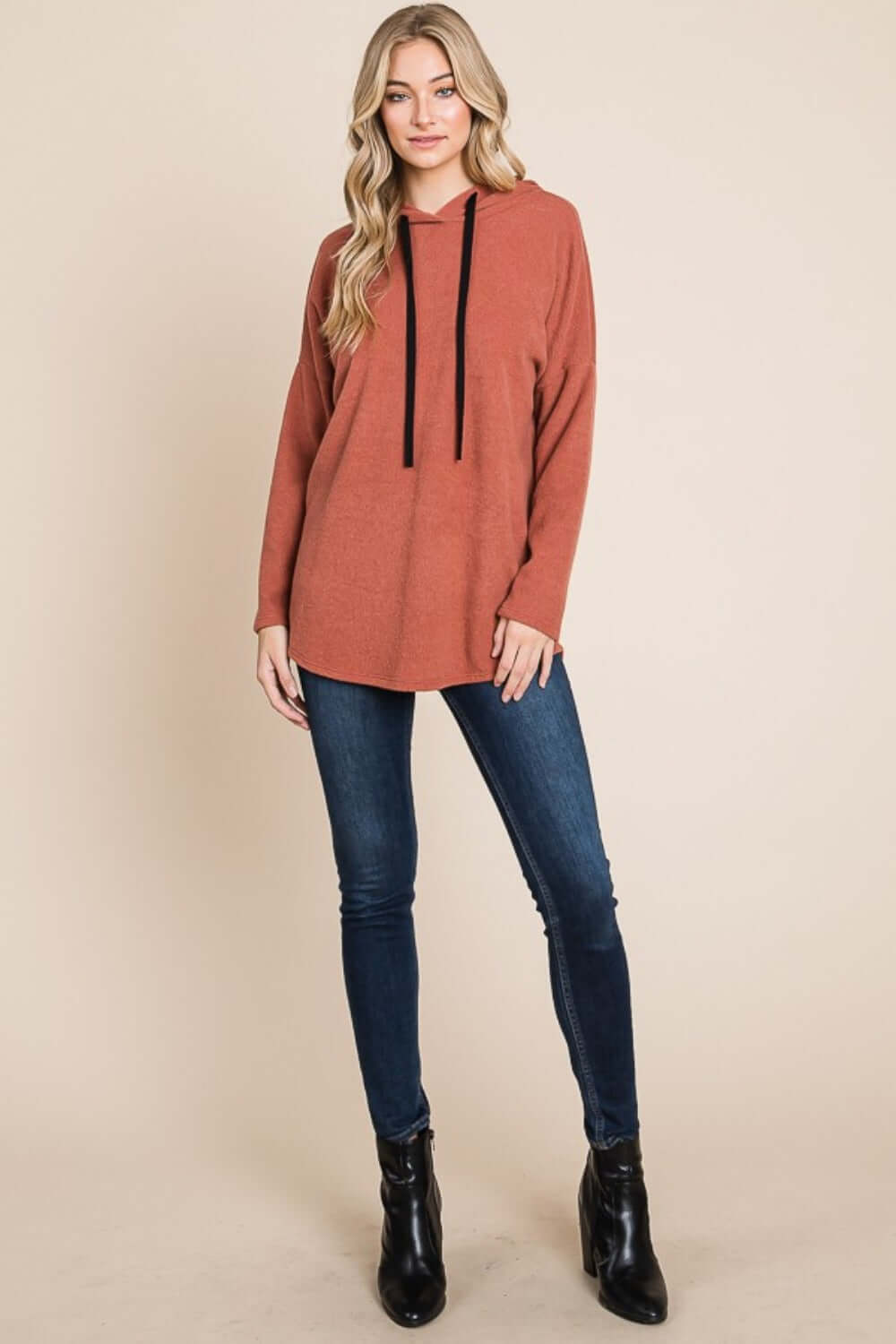 Woman wearing BOMBOM Contrast Drawstring Drop Shoulder Knit Hoodie with long sleeves and jeans, showcasing a cozy and stylish look.